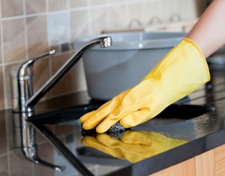 Cleaner working in a Fulham apartment hallway