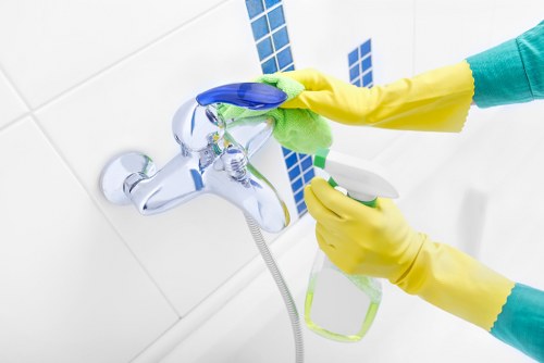 Kitchen surfaces being thoroughly cleaned in a Fulham property