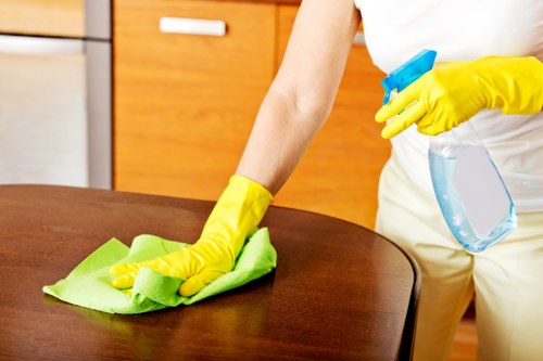 Local sofa cleaning technician treating stains on a sofa in Fulham